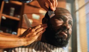 man getting hair cut in barbershop