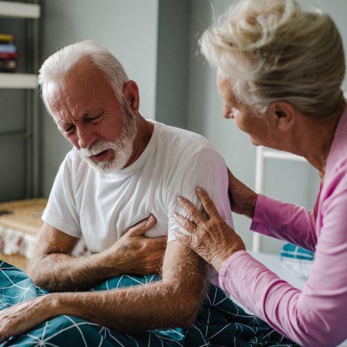Senior man suffering from a heart attack at home
